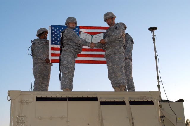 Soldier re-ups atop network vehicle
