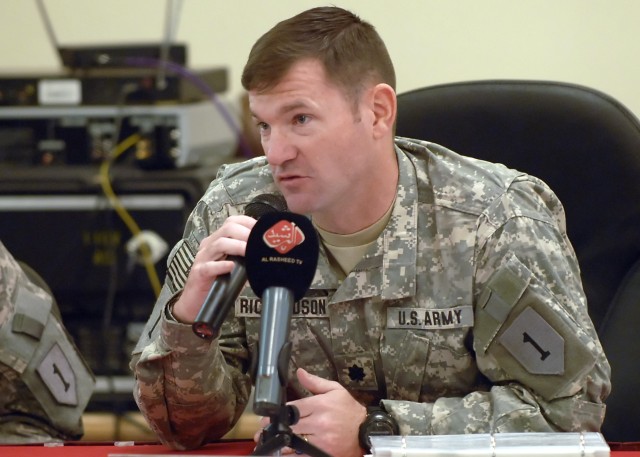 BAGHDAD - Lt. Col. John Richardson, IV, a native of Tallahassee, Fla., commander, 5th Squadron, 4th Cavalry Regtiment, 2nd Heavy Brigade Combat Team, 1st Infantry Division, Multi-National Division - Baghdad, speaks to several members of the Iraqi med...