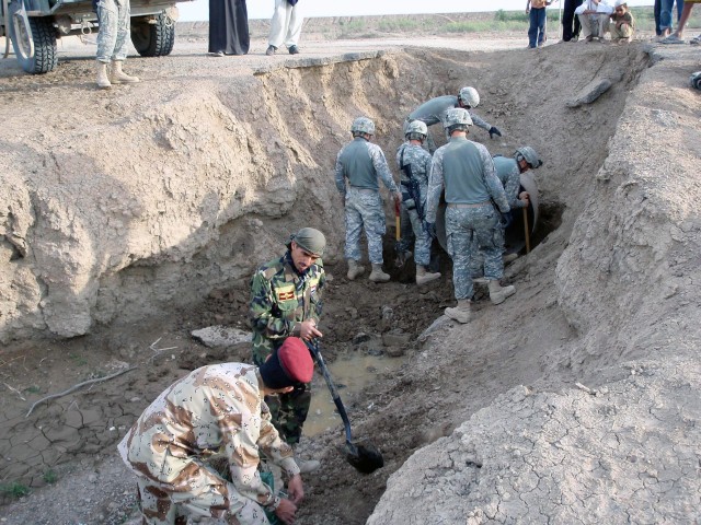 Soldiers with 2nd Battalion, 41st Iraqi Army Brigade, and 5th Battalion, 82nd Field Artillery Regiment, 4th Brigade Combat Team, 1st Cavalry Division repair Route Phoenix, a damaged roadway traveled by Coalition forces and the local Iraqi...