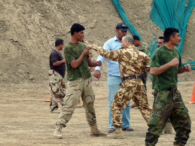 Soldiers assigned to the 26th Romanian Infantry Battalion teach troops from the 3rd Battalion, 39th Iraqi Army Brigade Shotokan, a unique style of martial arts used in hand-to-hand combat, during the first phase of their commando training on Camp...