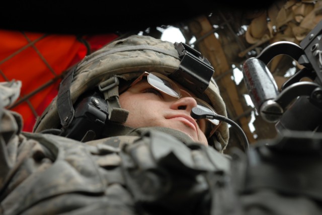 BAGHDAD - Pfc. Lee Mickelson, a military policeman and gunner, who hails from Enning, S.D., assigned to the 591st MP Company "Spartans," 93rd MP Battalion, 8th MP Brigade, mans the .50 caliber machine gun providing over watch for his fellow...