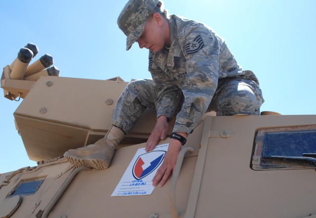 Tech. Sgt. Long places AMC decal