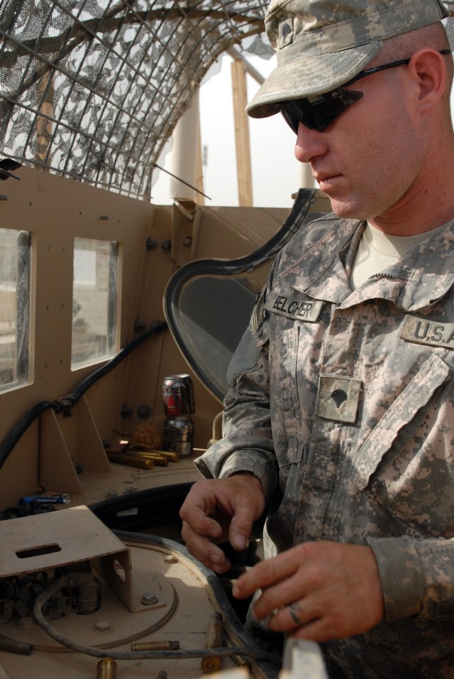 Spc. James Belcher, a personal security detail gunner from Paducah, Ky., assigned to Headquarters Support Company, 46th Engineer Battalion, 225th Engineer Brigade, checks the turret and cleans up brass after a mission at Camp Liberty, April 28. Belch...