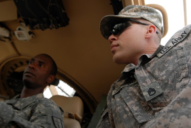 Spc. Kenneth James (left), a mechanic from Brooklyn, N.Y., and Staff Sgt. Scott Daigrepont (right), the personal security detail NCOIC both assigned to Headquarters Support Company, 46th Engineer Battalion, 225th Engineer Brigade, perform functions c...