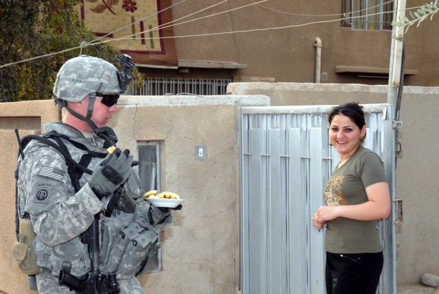 BAGHDAD - Sgt. Andy Zeigler, a military policeman assigned to Headquarters Company, Brigade Special Troops Battalion, 3rd Brigade Combat Team, 82nd Airborne Division, eats a few cookies that were given to him by a local woman, April 30, in appreciati...