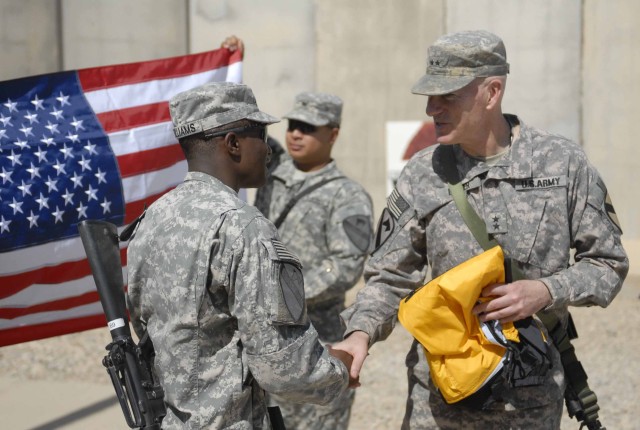 Maj. Gen. Daniel Bolger, Commander of Multi-National Division-Baghdad and the First Cavalry Division, congratulates Pfc. Gary Williams, assigned to the 4th Brigade Special Troops Battalion, 4th Brigade Combat Team, 1st Cavalry Division, after...