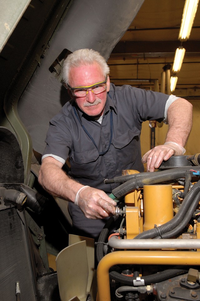 Mechanics repair military tactical vehicles