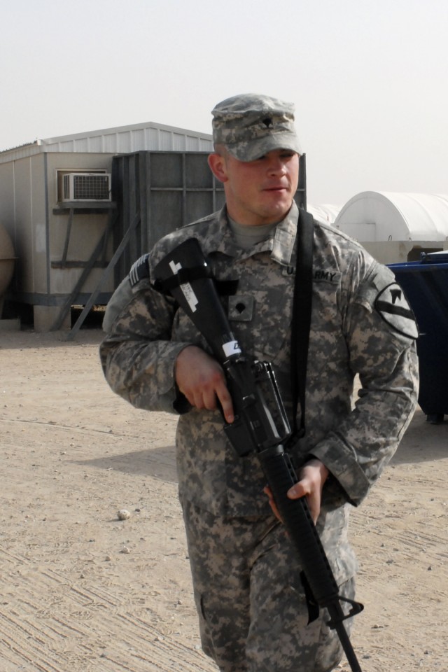 Spc. Timothy Edmonds, from Elmwood, Tenn., paralegal specialist, 1st Air Cavalry Brigade, 1st Cavalry Division, surveys his surroundings at Camp Buehring, Kuwait, May 4, as he undergoes mandatory training as part of his first deployment in support...