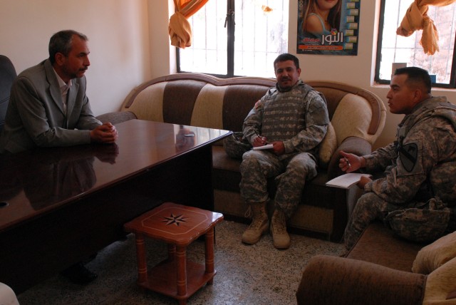 Sgt. 1st Class Miguel Casarez (right), San Antonio, Texas native, and a platoon sergeant in 4th Squadron, 9th Cavalry Regiment, 2nd Brigade Combat Team, 1st Cavalry Division, meets with Salah Wahiz Hassad, a teacher at a primary school in Arab Kuy...
