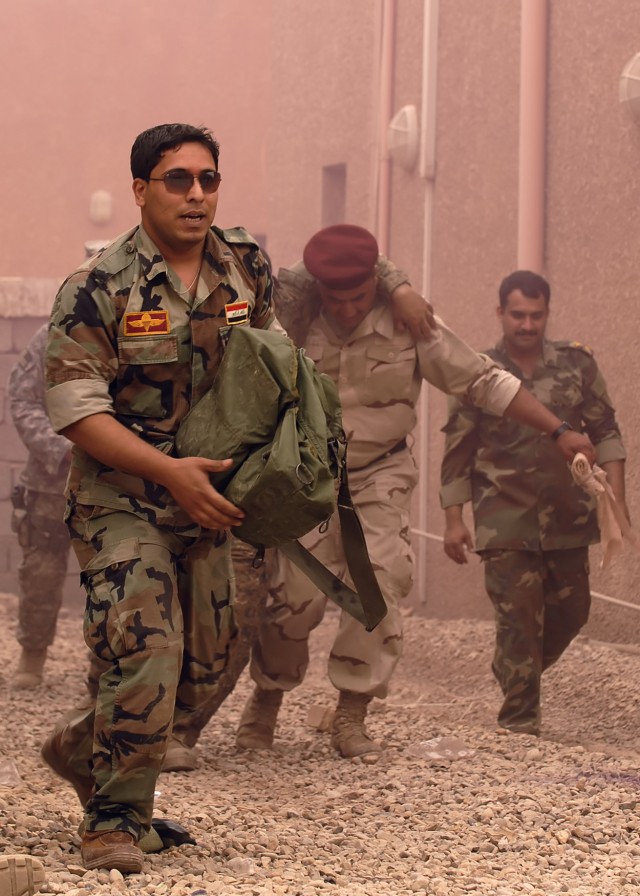 BAGHDAD - Iraqi Soldiers serving with the 6th Iraqi Army Division look for "wounded" Iraqi Soldiers in a simulated environment during training in northwest Baghdad May 6. The 6th IA Soldiers spent five days learning Combat Life Saver skills from...