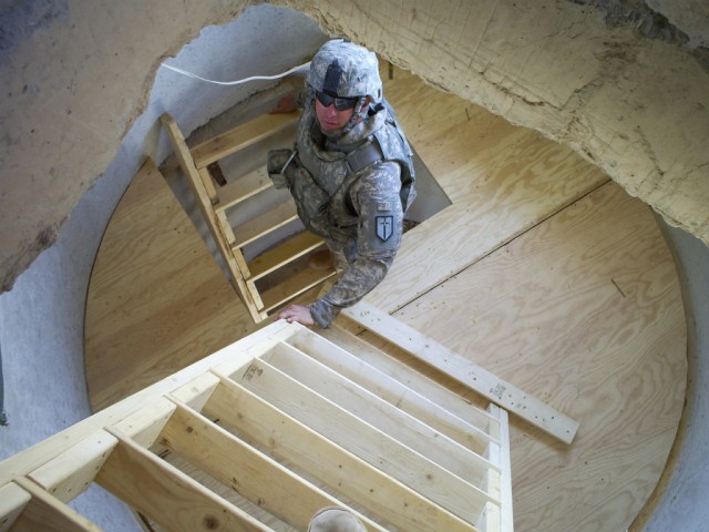 BAGHDAD - Sgt. Mark Jordan, team leader, 46th Engineer Combat Battalion (Heavy), 225th Eng. Brigade, from San Antonio, climbs the ladders to the top of the newly renovated guard tower. "Teaching sustainment operations is what it's all about,"...