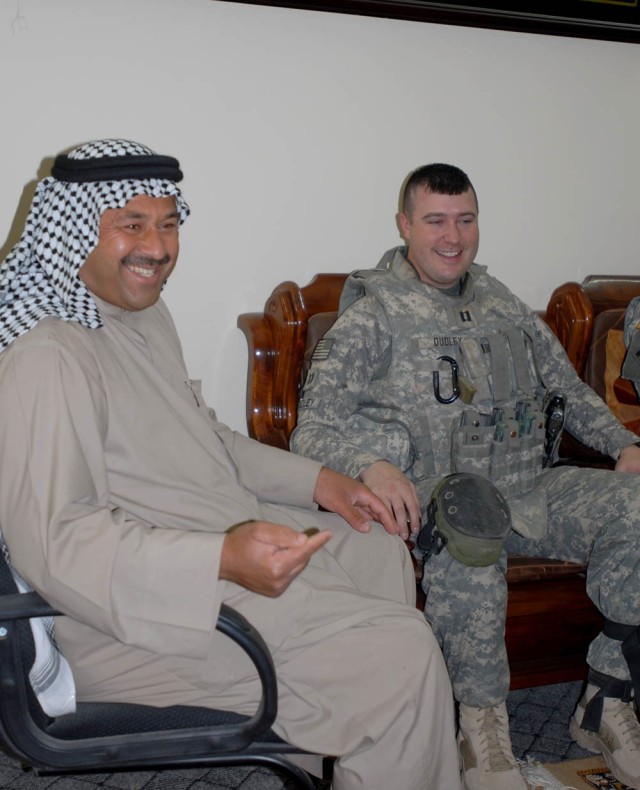 BAGHDAD - Newport News, Va. native, Capt. Jason Dudley (right), company commander for Headquarters and Headquarters Company, 1st Battalion, 5th Cavalry Regiment, attached to the 1st Brigade Combat Team, 1st Cavalry Division, talks with Kuwaiti...