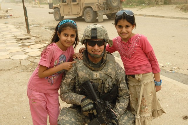 BAGHDAD - 2nd Lt. Christopher Esquivel, a fire support officer for Headquarters and Headquarters Company, 1st Battalion, 5th Cavalry Regiment, attached to the 1st Brigade Combat Team, 1st Cavalry Division takes time during a May 5 patrol down the...