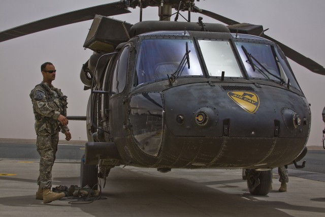 On the flight line of Camp Beurhing, Kuwait, Chief Warrant Officer 2 Eric Huff from San Diego, a UH-60 Black Hawk helicopter pilot in Company B, 3rd Assault Helicopter Battalion, 227th Aviation Regiment, 1st Air Cavalry Brigade, 1st Cavalry...