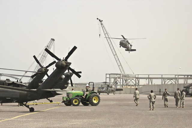 A UH-60 Black Hawk medevac helicopter from the 1st Air Cavalry Brigade, 1st Cavalry Division, comes in for a landing after a maintenance test flight at the port in Kuwait. After the aircraft spend numerous days on a ship, they are reassembled and...