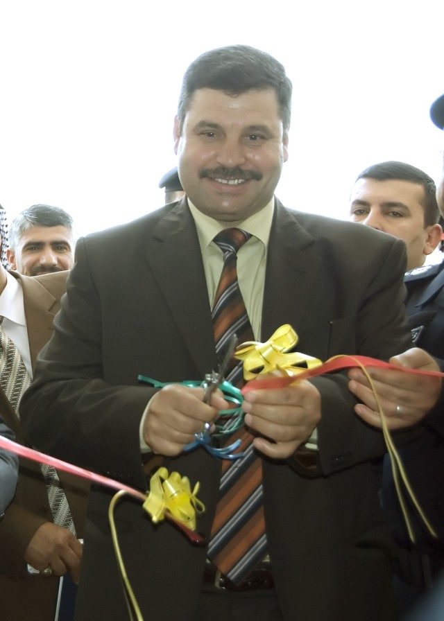 BAGHDAD -  Provincial Council representative Taha Dif Aaee cuts the ceremonial ribbon at the new Abu Ghraib Civil Defense Directorate in Abu Ghraib May 7. The ceremony was attended by many local government and civic leaders as well as officials...