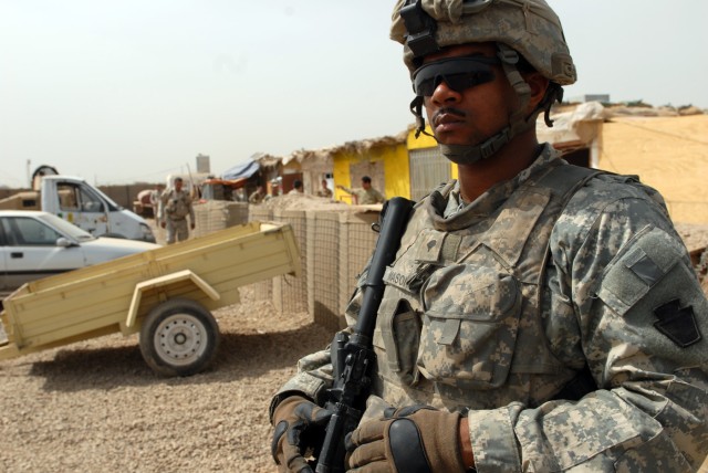 BAGHDAD – Spc. Wayne Mason, a native of Columbus, Ohio, and an infantryman assigned to 3rd Platoon, C Troop, 2nd Squadron, 104th Cavalry Regiment, 56th Stryker Brigade Combat Team, stands guard outside an Iraqi Army headquarters in northern...