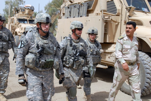 BAGHDAD - Brig Gen. John Murray (left), deputy commander for maneuver for Multi-National Division-Baghdad and the 1st Cavalry Division, walks with Lt. Col. Dave Bair, from Fairfax, Va., commander of 1st Bn., 505th Parachute Infantry Regiment, May...