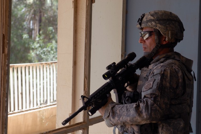 BAGHDAD - Spc. Forat Aldawoodi, 1st Battalion, 505th Parachute Infantry Regiment, pulls security at an Iraqi Army compound in the remains of a hotel, May 7. The Pawtucket, R.I. native keeps watch to ensure the safety and security of Brig Gen. John...