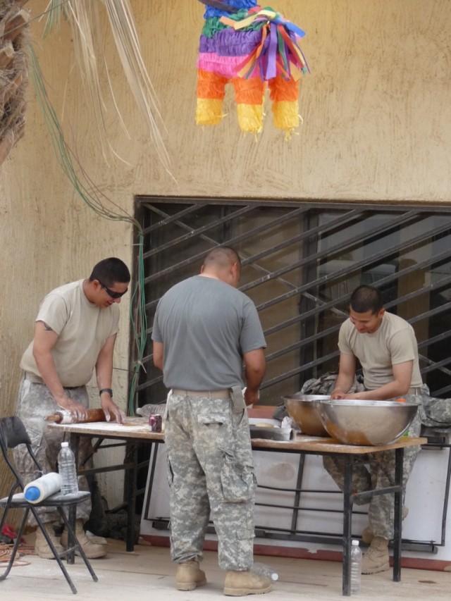 BAGHDAD - A colorful piñata hangs above Soldiers from the 277th Engineer Company, 46th Engineer Combat Battalion (Heavy), a Reserve unit based mainly in San Antonio, Texas, preparing authentic tortillas for the "Cinco de Mayo" Engineer Call, 9 May.  ...