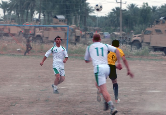 BAGHDAD -1st Lt. Paul Wistermayer, assistant intelligence officer  with Headquarters and Headquarters Company, 1st Battalion, 505th Parachute Infantry Regiment, prepares to clear the ball from his side of the field during a preliminary match of...