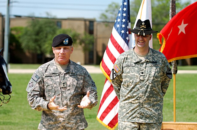 Maj. Gen. Jeffery Hammond, 4th Infantry Division (Mechanized) commanding general, speaks about Col. Jeffrey Sauer, 1st Cavalry Division Rear Detachment commander, before pinning on Sauer's new rank May 4, in front of the 1st Cav. Div. Headquarters on...