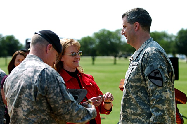 Maj. Gen. Jeffery Hammond, 4th Infantry Division (Mechanized) commanding general, and Sarah Sauer pinned on 1st Cavalry Division Rear Detachment's commander, Col. Jeffrey Sauer's new rank May 4, in front of the 1st Cav. Div. Headquarters on Fort Hood...