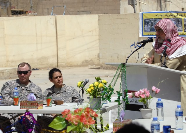 BAGHDAD - Sheik Maqmoud al-Falahi (right), a tribal leader in northwest Baghdad, speaks to attendees of the "Hurriyah Walkthrough" ceremony in the Kadamiyah district of northwest Baghdad May 11. After the ceremony civic leaders and members of the...