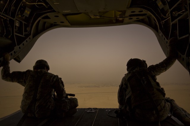 Spc. Mitchell Peterson (right), from Buckeye, Arizona, a CH-47F Chinook helicopter crew chief in Company B, 2nd General Support Aviation Battalion, 227th Aviation Regiment, 1st Air Cavalry Brigade, 1st Cavalry Division, and Sgt. Nathan Hoskins (left)...