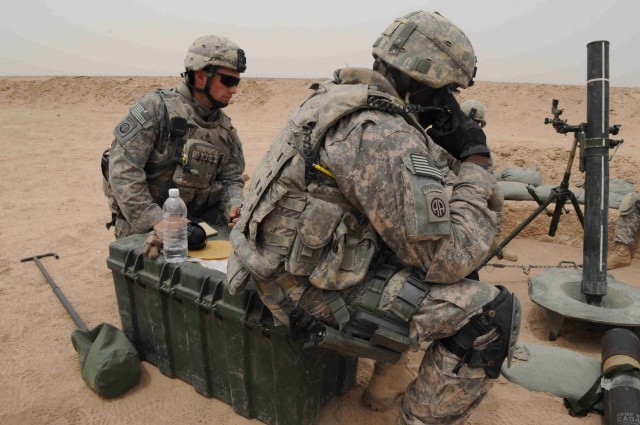 BAGHDAD - Sgt. Ryan Crawford (right) and Sgt. 1st Class Milton Terrell, both with 3rd Brigade Combat Team, 82nd Airborne Division, prepare to fire a mortar round May 8 on the live fire range at Joint Security Station Loyalty. The Paratroopers,...