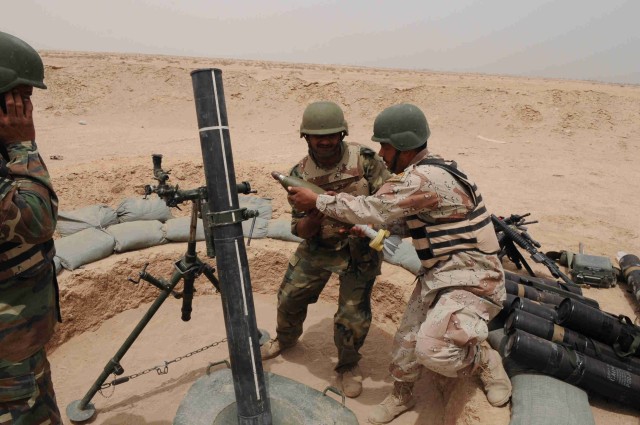 BAGHDAD - Iraqi Army soldiers assigned to 35th Iraqi Army Brigade, 9th Iraqi Army Division, prepare to fire a mortar round on, May 8, at Joint Security Station Loyalty.  IA troops partnered with U.S. Paratroopers from 3rd Brigade Combat Team, 82nd...