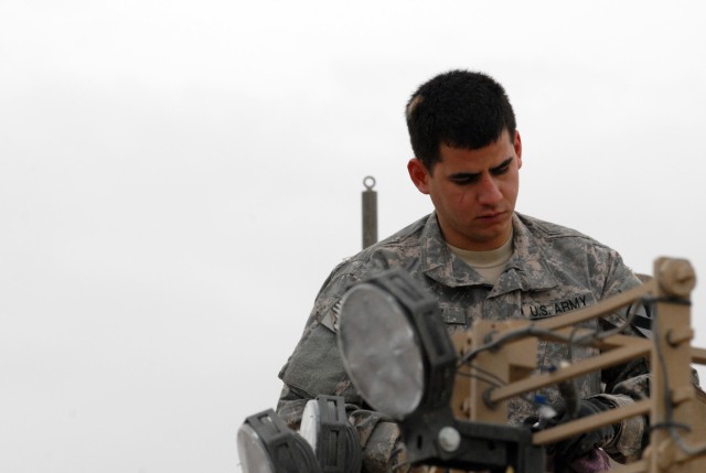 BAGHDAD - Staff Sgt. Sergio Lopez, a combat engineer, assigned to Company E, 2nd Battalion, 5th Cavalry Regiment conducts a preventive maintenance checks and services on the mechanical arm of his vehicle before going on a mounted patrol May 10.  "The...