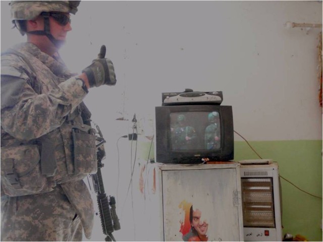 BAGHDAD-Capt. Jordan Enger, commander of Troop A, 1st "Garryowen" Squadron, 7th Cavalry Regiment, 1st Brigade Combat Team, 1st Cavalry Division, gives a thumbs up to a manager at an Iraqi business on May 4.  During a neighborhood patrol, Soldiers...