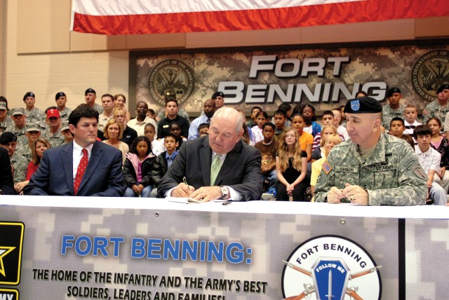 Perdue visits post, signs education bills for children