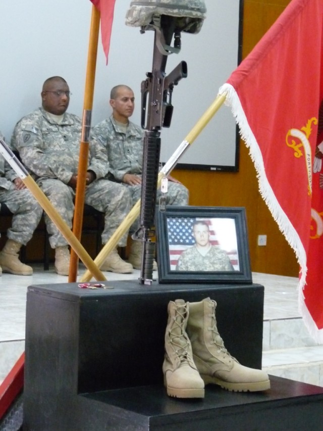CAMP LIBERTY - Spc. Jacob Barton's "stairway to heaven" display is in the foreground as Spc. Jason Mata (left) and Sgt. 1st Class Carlos Vargas (right), both with the 277th Engineer Company based in San Antonio, TX, silently prepare to give their eul...