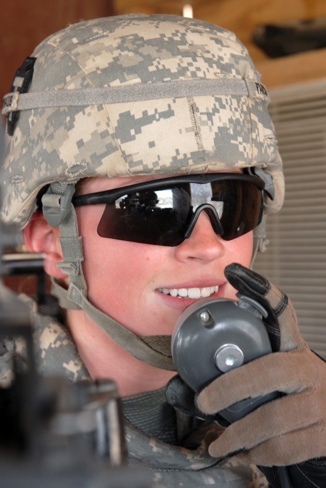 BAGHDAD - In a tower at an entry control point at Victory Base Complex here, May 14, Spc. Janice Parisi, an intelligence analyst assigned to Apache Troop, 1st Squadron, 124th Cavalry Regiment, keeps traffic flowing through her ECP by giving...