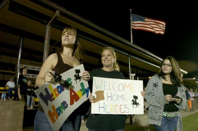 Cylia Amacker (left), Stacy Foreman, and Melissa Saxton, look out for the buses Pfc. Ethan Amacker, 2nd Battalion, 7th Cavalry Regiment, 4th Brigade Combat Team, 1st Cavalry Division, and more than 200 other Soldiers came back on May 14, at a...