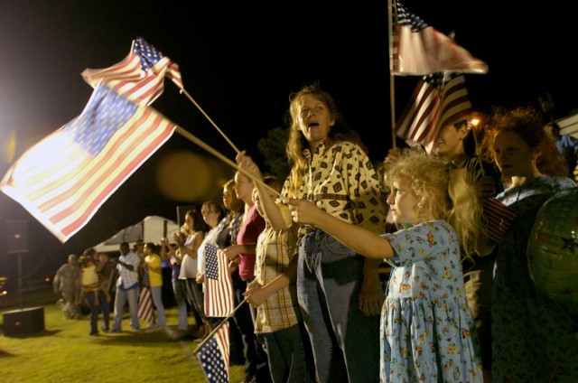 Becky Pemberton and her two daughters, Hannah, 6, and Breanne, 8, wait for the buses Pfc. Anthony Pemberton, 2nd Battalion, 7th Cavalry Regiment, 4th Brigade Combat Team, 1st Cavalry Division, and more than 200 other Soldiers came back on May 14,...