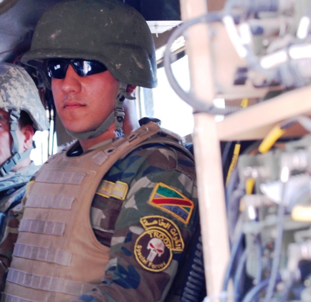 BAGHDAD - Sgt. Bassam ,an 11th Iraqi Army Engineer Regiment Soldier, rides along with members of the 515th Engineer Sapper Company, attached to the 225th Engineer Brigade, May 13, as U.S. and IA engineers train together on route clearance tactics....