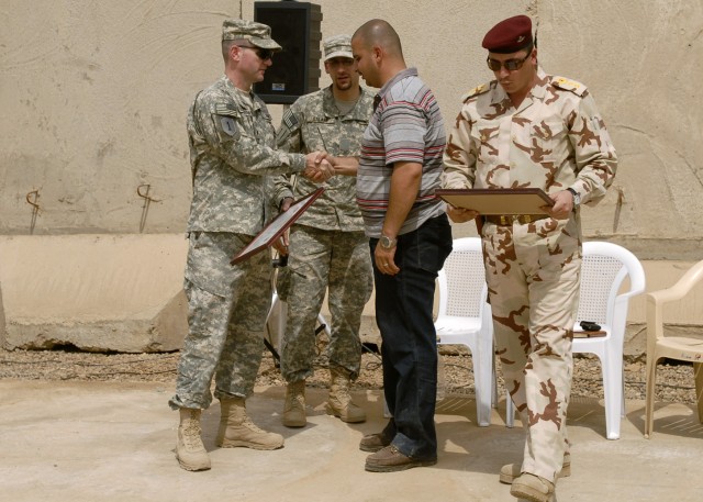 BAGHDAD - Lt. Col. John Richardson (left), commander, 5th Squadron, 4th Cavalry Regiment, 2nd Heavy Brigade Combat Team, 1st Infantry Division, Multi-National Division - Baghdad, and Lt. Col. Ali (right), commander, 2nd Battalion, 54th Brigade,...