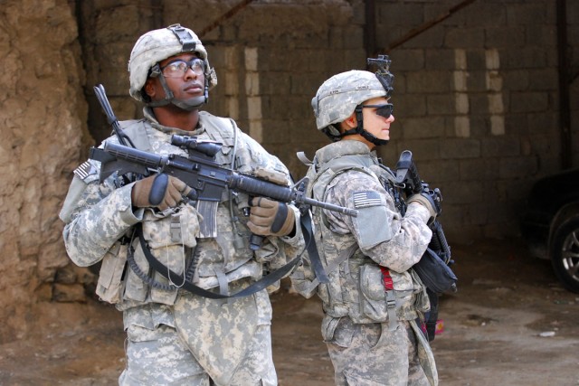 1st Sgt. Rice and Pfc. Gomez from B Company, 3rd Battalion, 8th Cavalry Regiment, 3rd Heavy Brigade Combat Team, 1st Cavalry Division move between clearing teams during Operation Warhorse Scimitar, a sweep, clear and census operation in west...