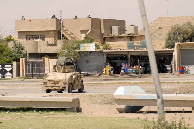 Troops with B Company, 1st Battalion, 67th Armor Regiment, 2nd Brigade Combat Team, 4th Infantry Division provide security from a rooftop near the site of a humanitarian aid distribution May 9 in the western Mosul neighborhood of Domiz. "My Soldiers ...