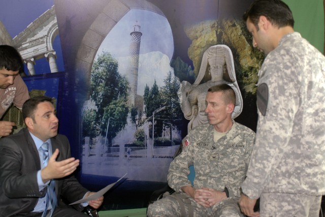 Col. Gary Volesky (seated, right), commander, 3rd Bde, 1st Cav. Div., talks with a news anchor before recording an interview that aired May 17 on Al Mosulia, a local Mosul news agency station. Volesky condemned Iraq's enemies for violence in Mosul an...