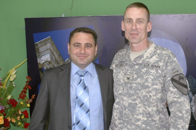 Col. Gary Volesky, commander, 3rd Bde, 1st Cav. Div., and a news anchor pose for a picture after recording an interview that aired May 17 on Al Mosulia, a local Mosul news agency station. Volesky discussed key security topics and concerns in Ninewa p...