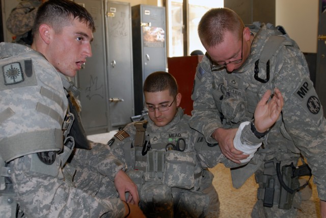 TAJI, Iraq - Spc. James Bagby, from Shelby N.C. (left), an assistant medic with 591st Military Police Company, 93rd MP Battalion, 8th MP Brigade, along with Pfc. Evan Meade, from Londonderry, N.H. (middle) and Pfc. Andrew Van Cleave, from Junction...