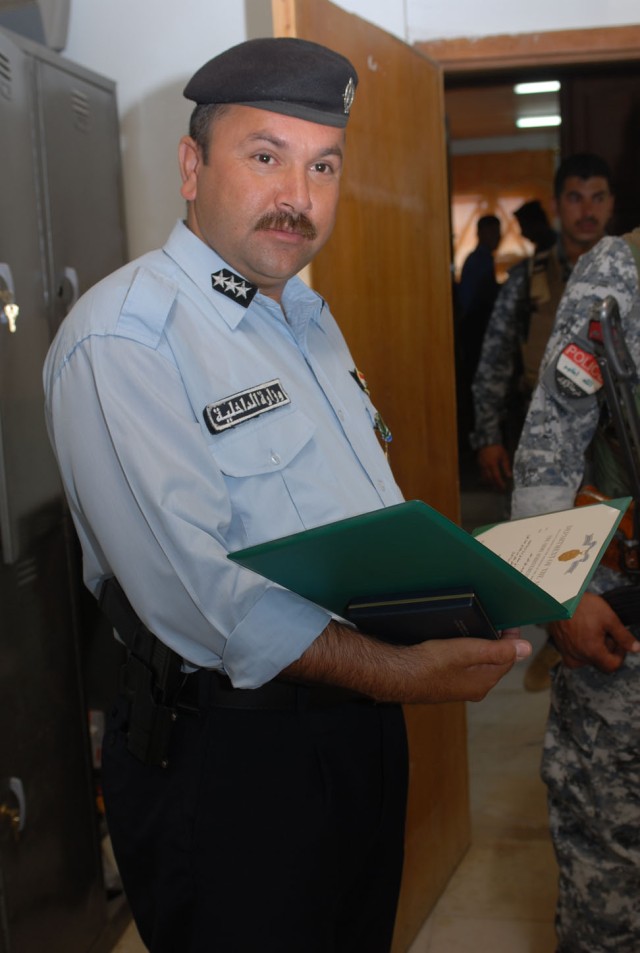 Sgt. Rafeeq Qadir Khidir, a policeman in Kirkuk city, Iraq, looks up for a moment from...