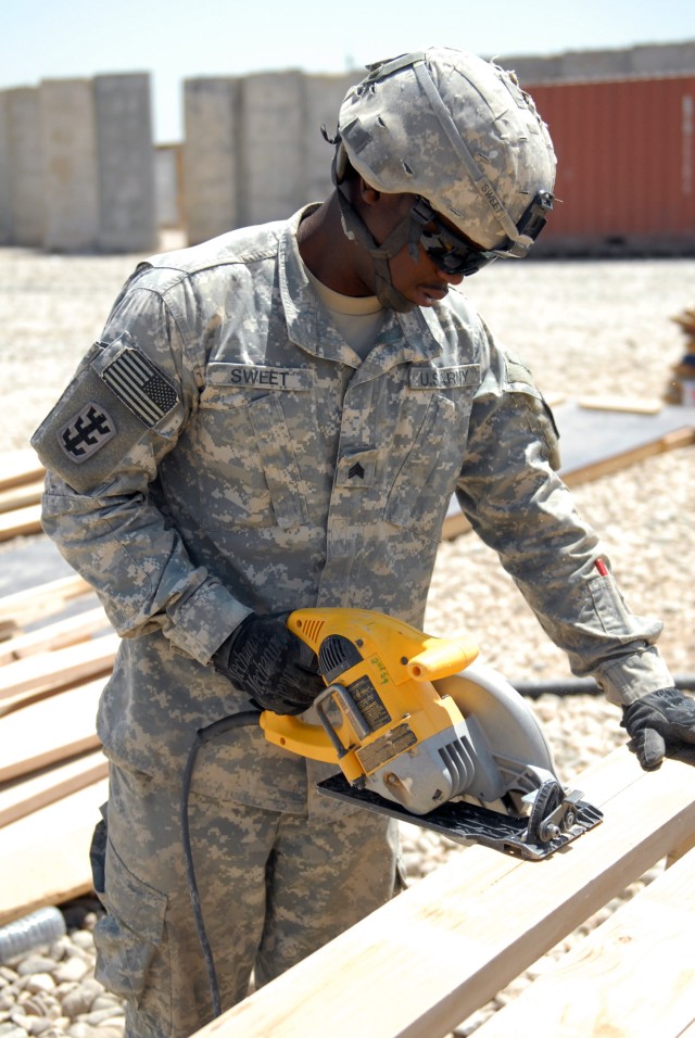 BAGHDAD - Sgt. Marques Sweet, of Compton, Calif., cuts a truss cord prior to the truss being assembled on a B-Hut at Combat Outpost Carver, May 18.  Sweet alongside his fellow Soldiers in the 46th Engineer Battalion, 225th Engineer Brigade, 1st Caval...