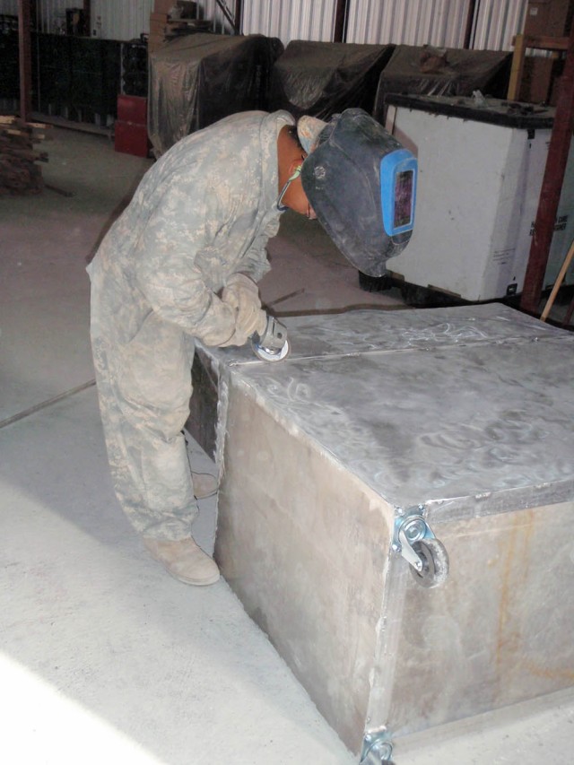 BAGHDAD-Honolulu, Hawaii native, Spc. Antonio Quebatay, of Troop D, 1st Squadron, 7th Squadron, 1st Brigade Combat Team, 1st Cavalry Division, grinds a sharp edge from a medical supply cart he constructed for use in the squadron aid station at...