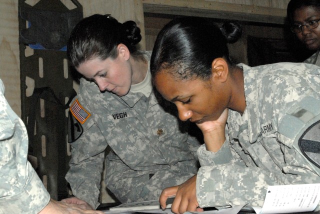 BAGHDAD - Gilbert, Ariz. native, Maj. Amber Vegh (left), officer in charge of the Battalion Aid Station for Company C, 115th Brigade Support Battalion, 1st Brigade Combat Team, 1st Cavalry Division and "Iron Medic" physicians assistant, 1st Lt....