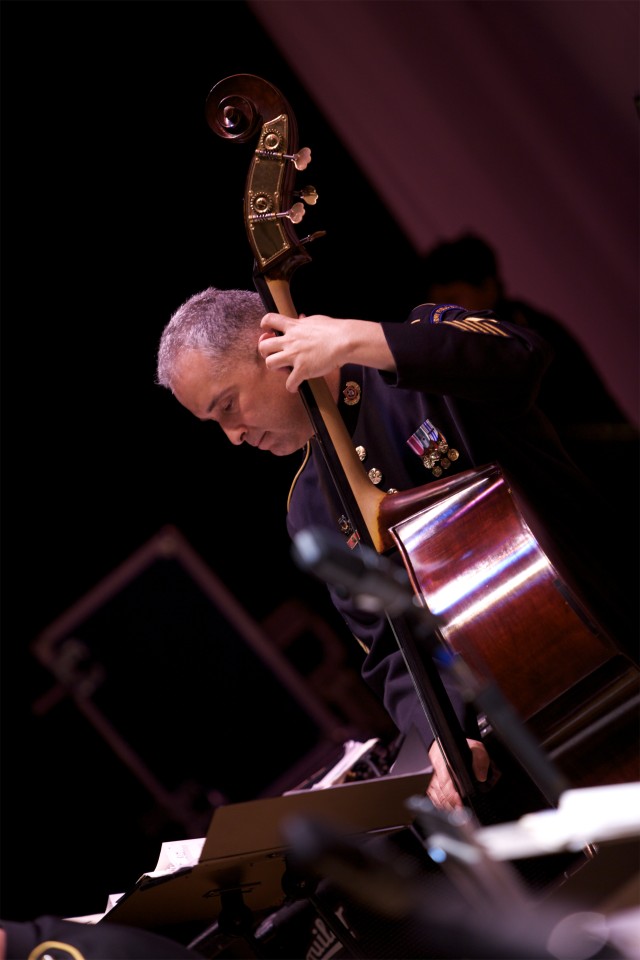 Master Sgt. Jeff Lopez plays bass during a concert at Delaware State University.